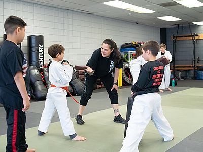 Coach instructing kids in a Young Warriors Krav Maga class at Colorado Krav Maga