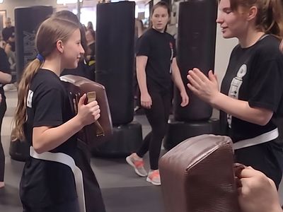 Teens practicing Krav Maga self-defense drills on pads at Colorado Krav Maga